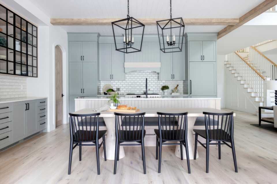 natural white oak floors in modern farmhouse kitchen with blue green cabinetry and wooden beams